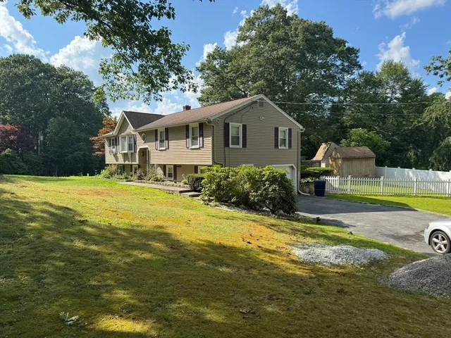 a view of a house with swimming pool and a yard