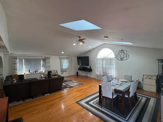 a living room with furniture a large window and a table