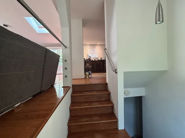 a view of entryway and hall with wooden floor