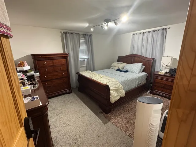 a bedroom with a bed and a mirror