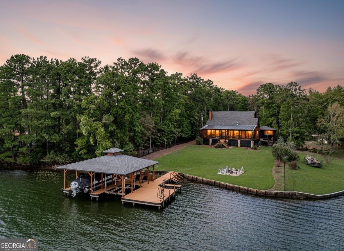 an aerial view of a house with swimming pool lake view and mountain view