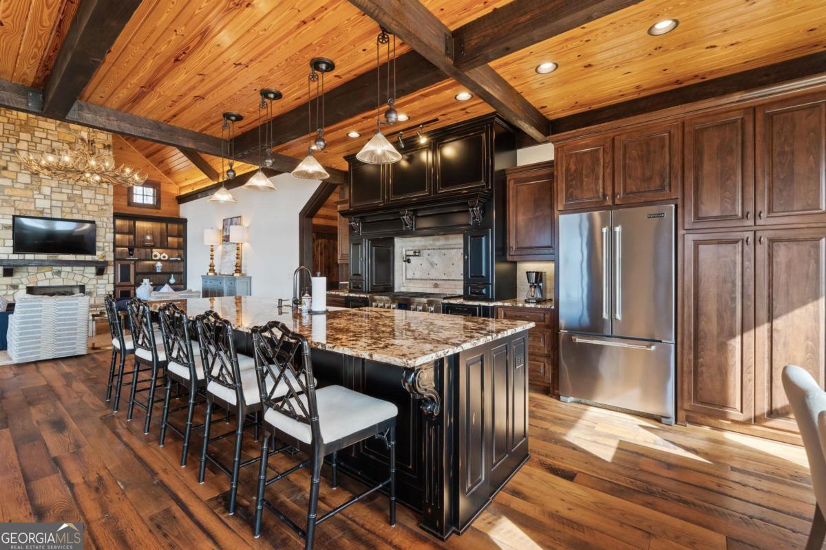4096 Big Water E Road Sparta, GA 31087 - Photo 23 of 72 a kitchen with stainless steel appliances granite countertop a table chairs and a refrigerator