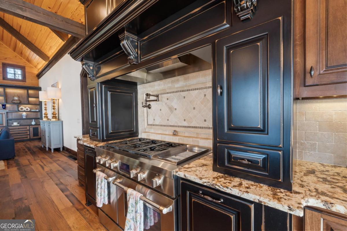 4096 Big Water E Road Sparta, GA 31087 - Photo 33 of 72 a kitchen with granite countertop a stove and cabinets