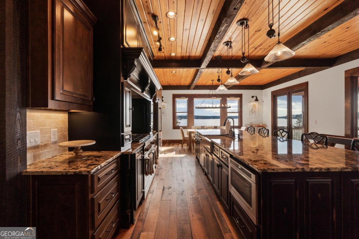 4096 Big Water E Road Sparta, GA 31087 - Photo 34 of 72 a kitchen with granite countertop lots of counter top space a sink and wooden floor