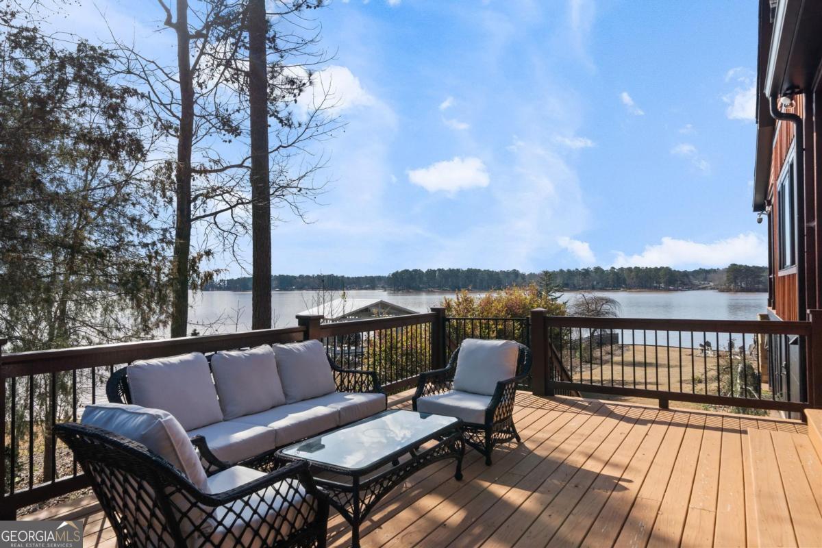 4096 Big Water E Road Sparta, GA 31087 - Photo 65 of 72 a balcony with wooden floor and outdoor seating