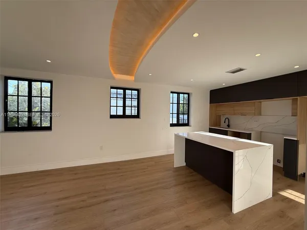 a kitchen with stainless steel appliances granite countertop a sink stove and wooden floor