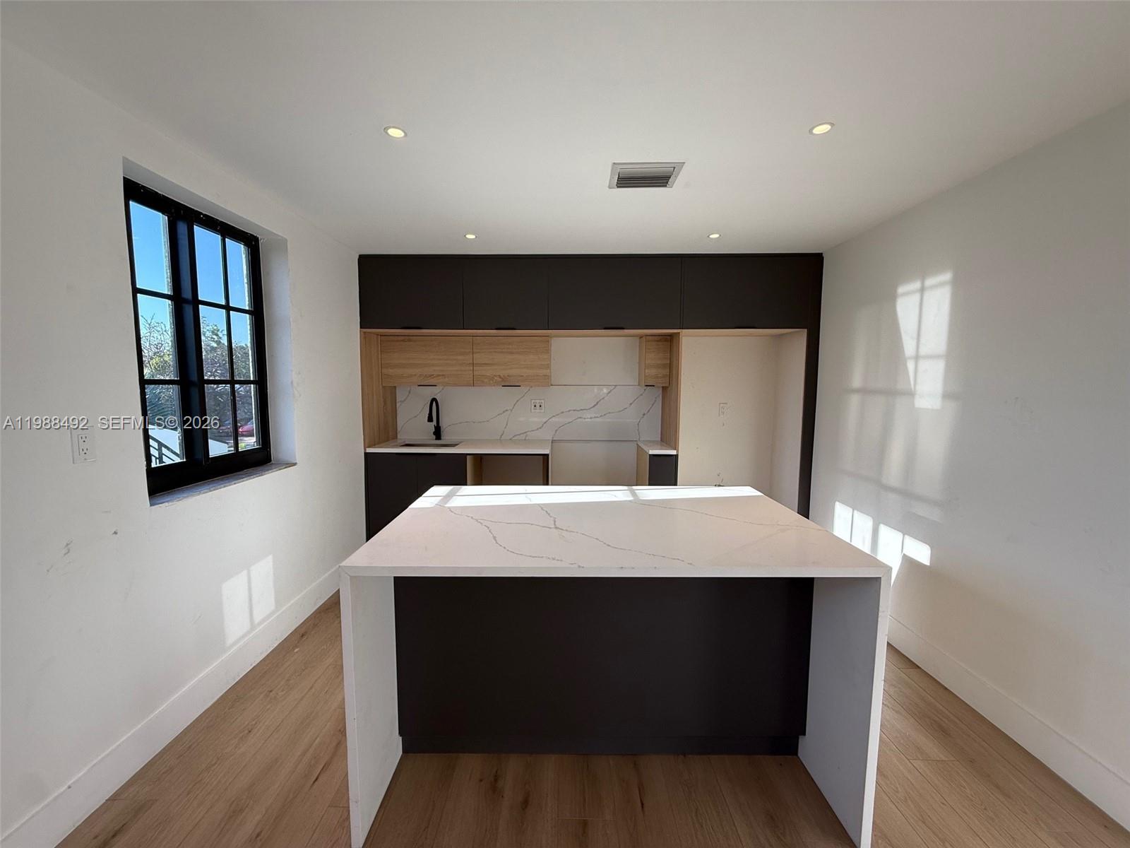 1716 Southwest 11th Street, Unit 4 Miami, FL 33135 - Photo 3 of 11 a room with a bed and a window