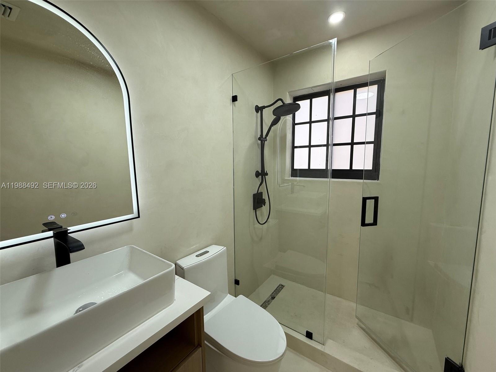 1716 Southwest 11th Street, Unit 4 Miami, FL 33135 - Photo 9 of 11 a bathroom with a sink toilet and shower