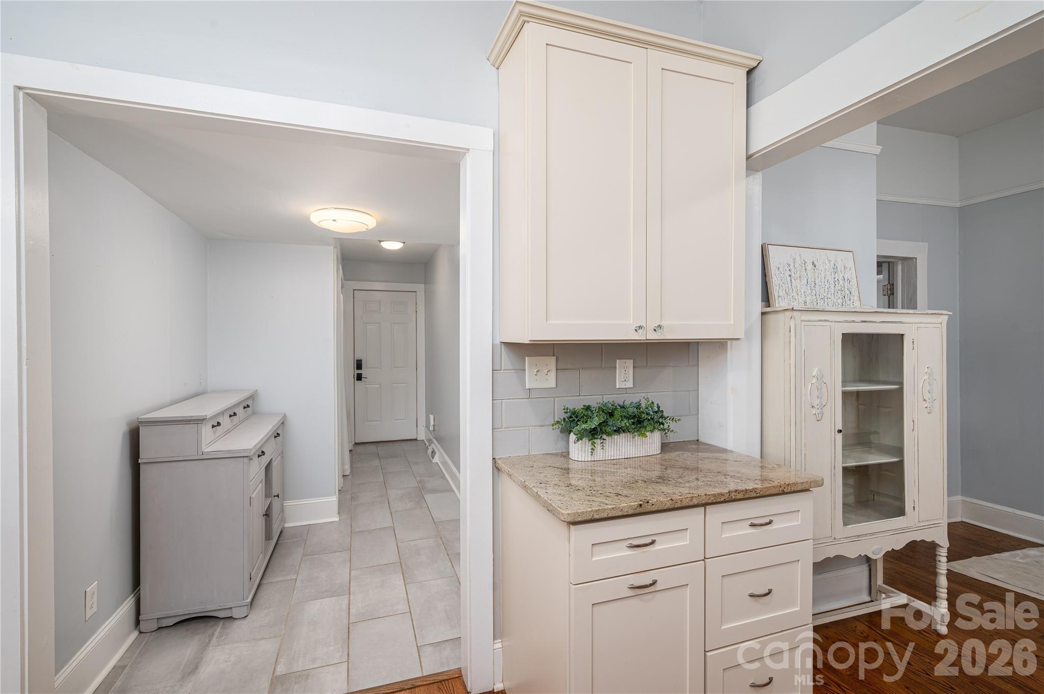 58 Fourth Street Cramerton, NC 28032 - Photo 24 of 44 a kitchen with granite countertop a white cabinets and window