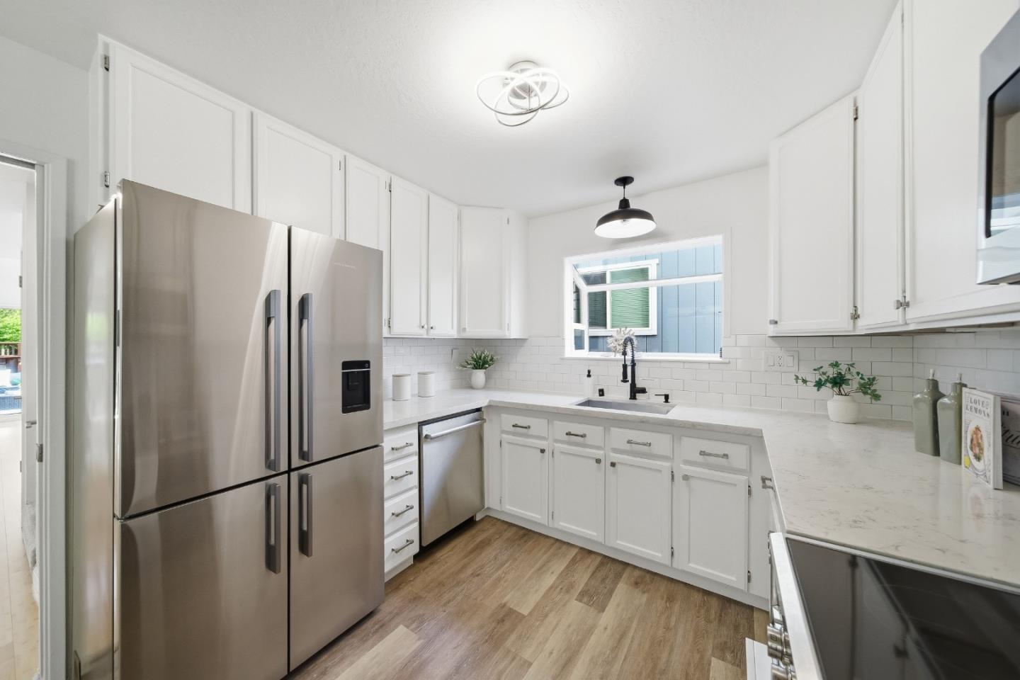 495 Ebken Street Pacifica, CA 94044 - Photo 18 of 52 a kitchen with stainless steel appliances a refrigerator sink and cabinets
