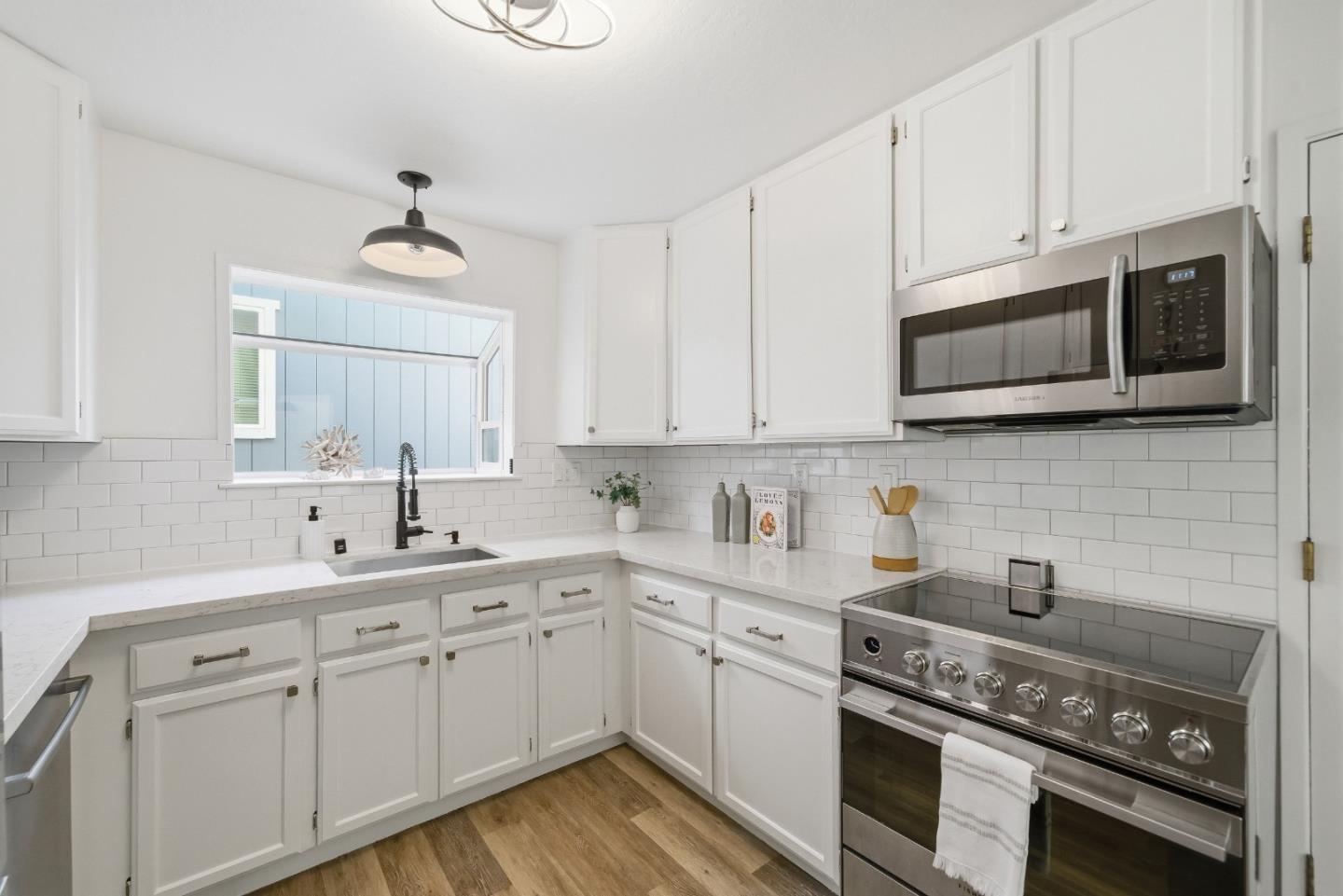 495 Ebken Street Pacifica, CA 94044 - Photo 19 of 52 a kitchen with stainless steel appliances white cabinets and a stove a sink