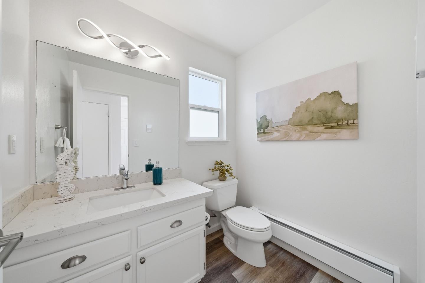 495 Ebken Street Pacifica, CA 94044 - Photo 25 of 52 a bathroom with a toilet a sink and mirror