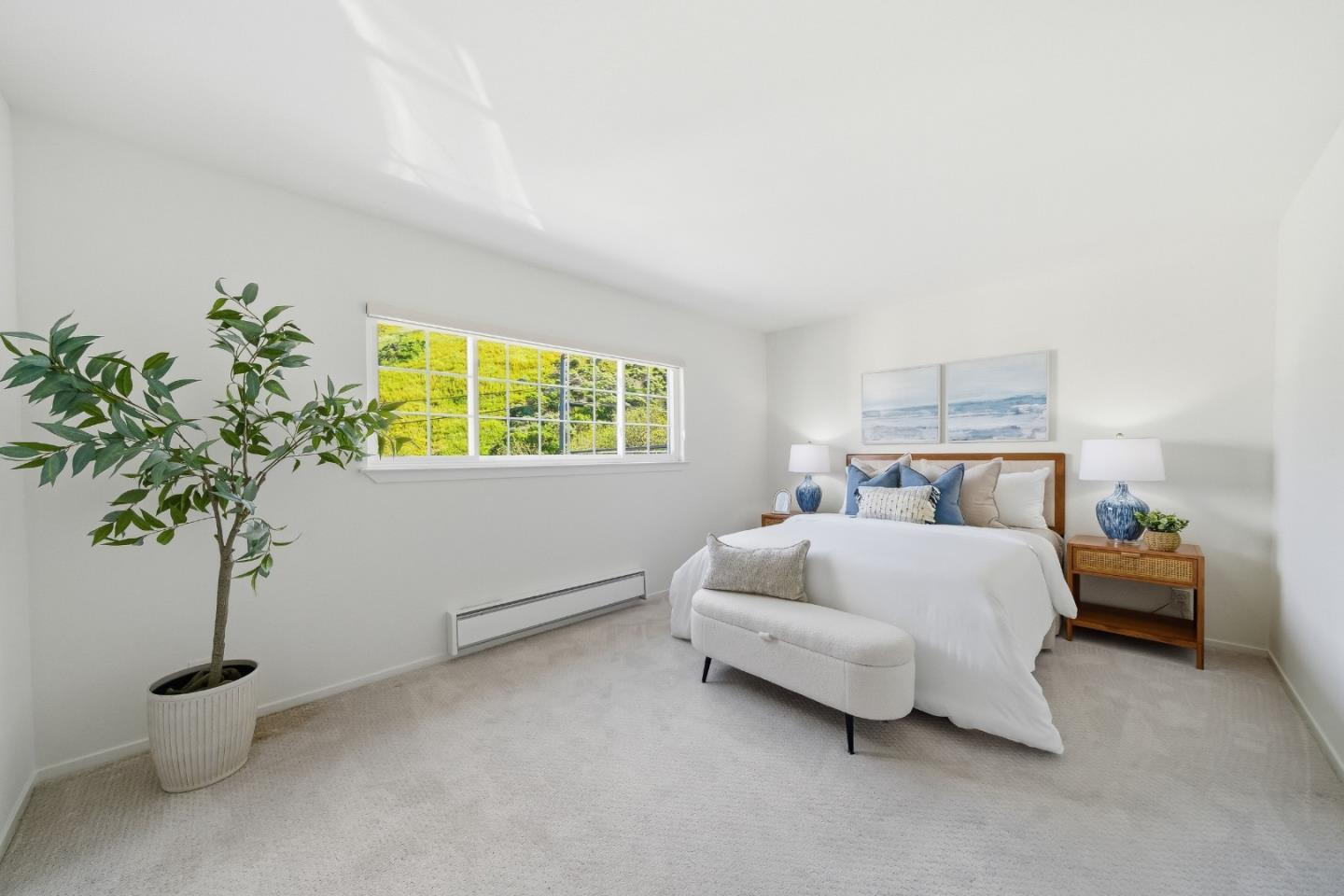 495 Ebken Street Pacifica, CA 94044 - Photo 28 of 52 a bedroom with a bed and a potted plant