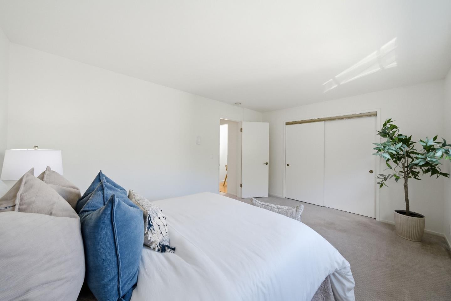 495 Ebken Street Pacifica, CA 94044 - Photo 31 of 52 a bedroom with a bed and a potted plant
