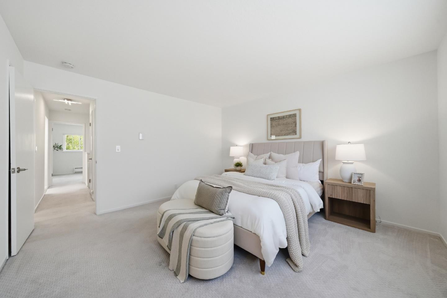 495 Ebken Street Pacifica, CA 94044 - Photo 34 of 52 a spacious bedroom with a bed and a lamp