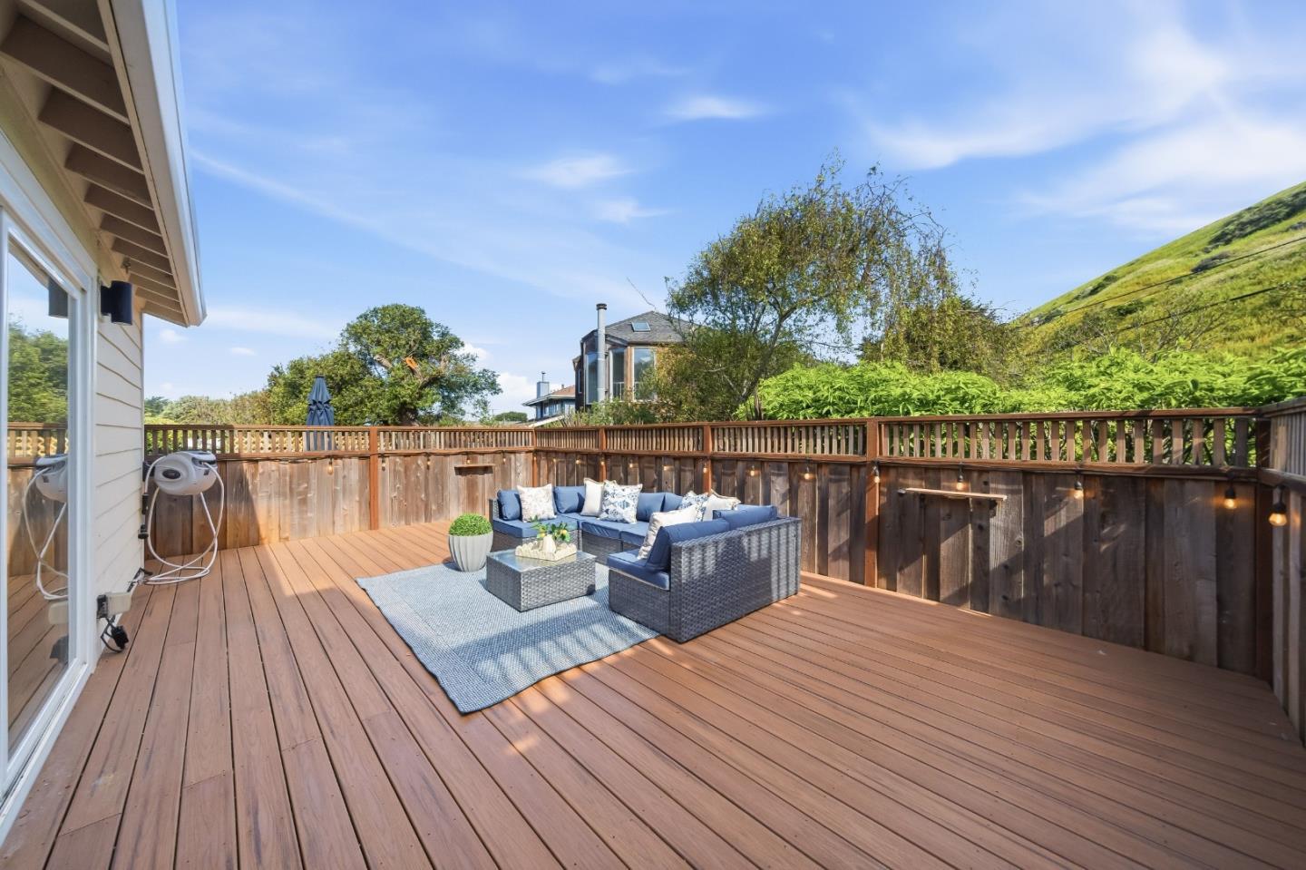 495 Ebken Street Pacifica, CA 94044 - Photo 46 of 52 a balcony with wooden floor table and chairs