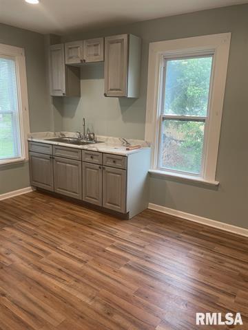 2228 9th Street Rock Island, IL 61201 - Photo 3 of 10 a kitchen with granite countertop a stove a sink and a wooden floors