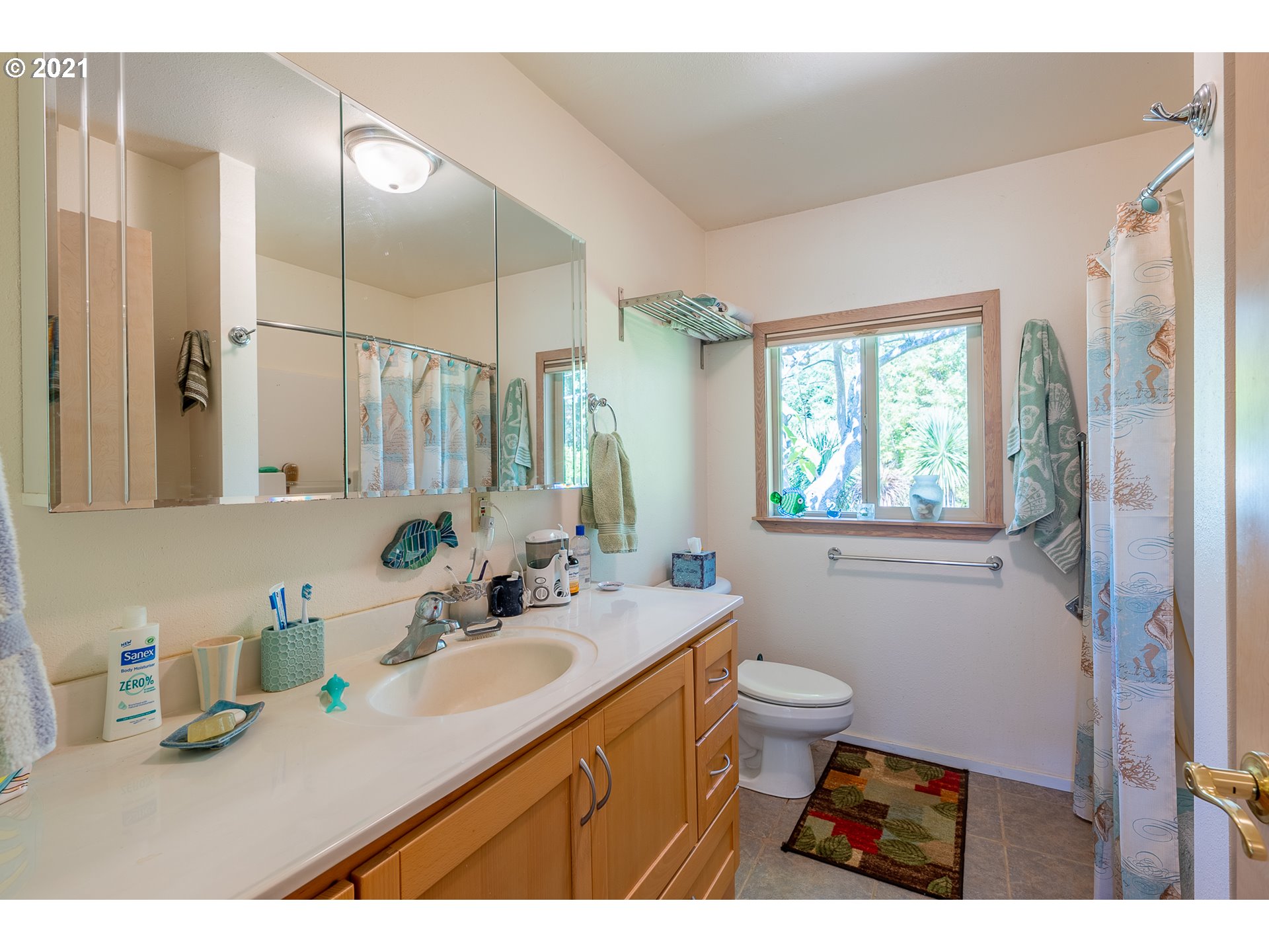 8715 Scholfield Road North Bend, OR 97459 - Photo 11 of 32 a bathroom with a sink double vanity granite and a toilet