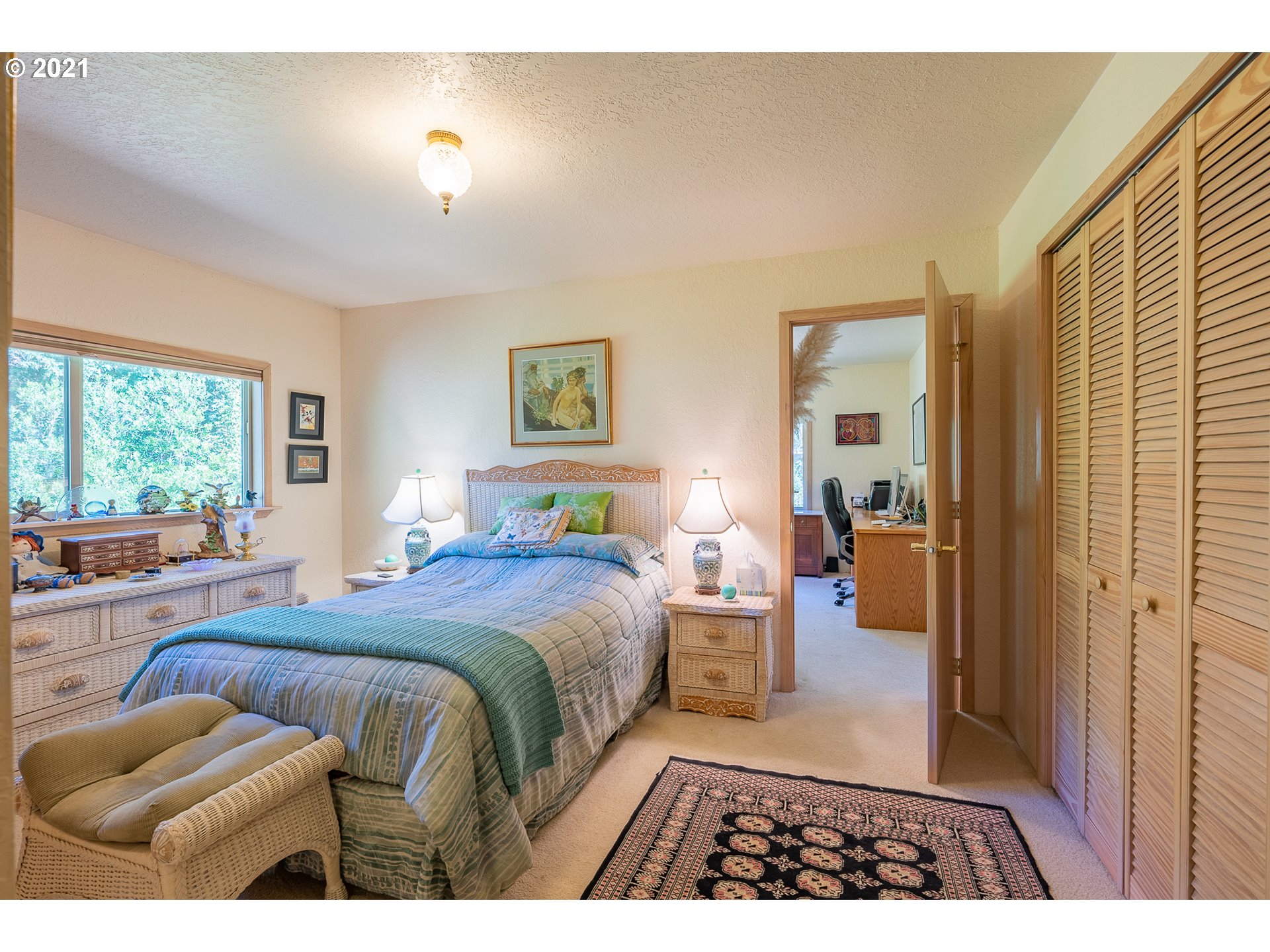 8715 Scholfield Road North Bend, OR 97459 - Photo 15 of 32 a bedroom with a bed and a couch
