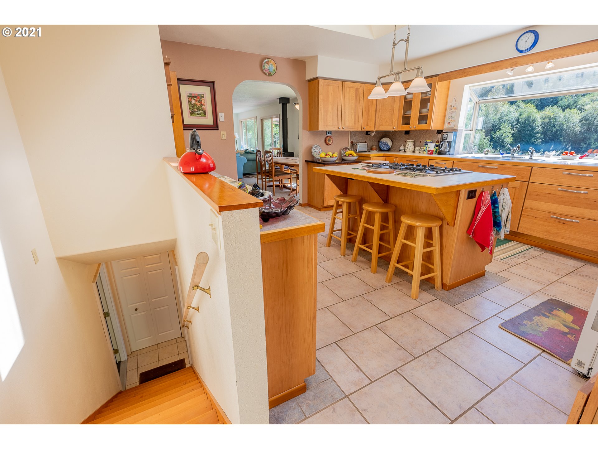 8715 Scholfield Road North Bend, OR 97459 - Photo 16 of 32 a open kitchen with stainless steel appliances granite countertop a stove a sink dishwasher and a refrigerator