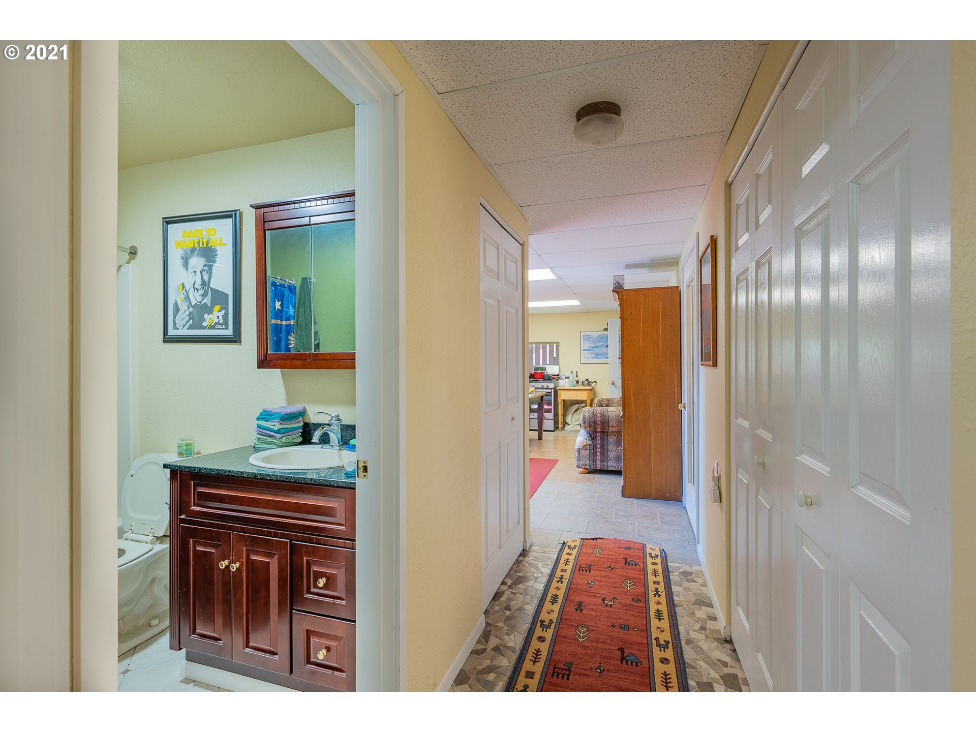 8715 Scholfield Road North Bend, OR 97459 - Photo 19 of 32 a hallway with furniture and a wooden floor