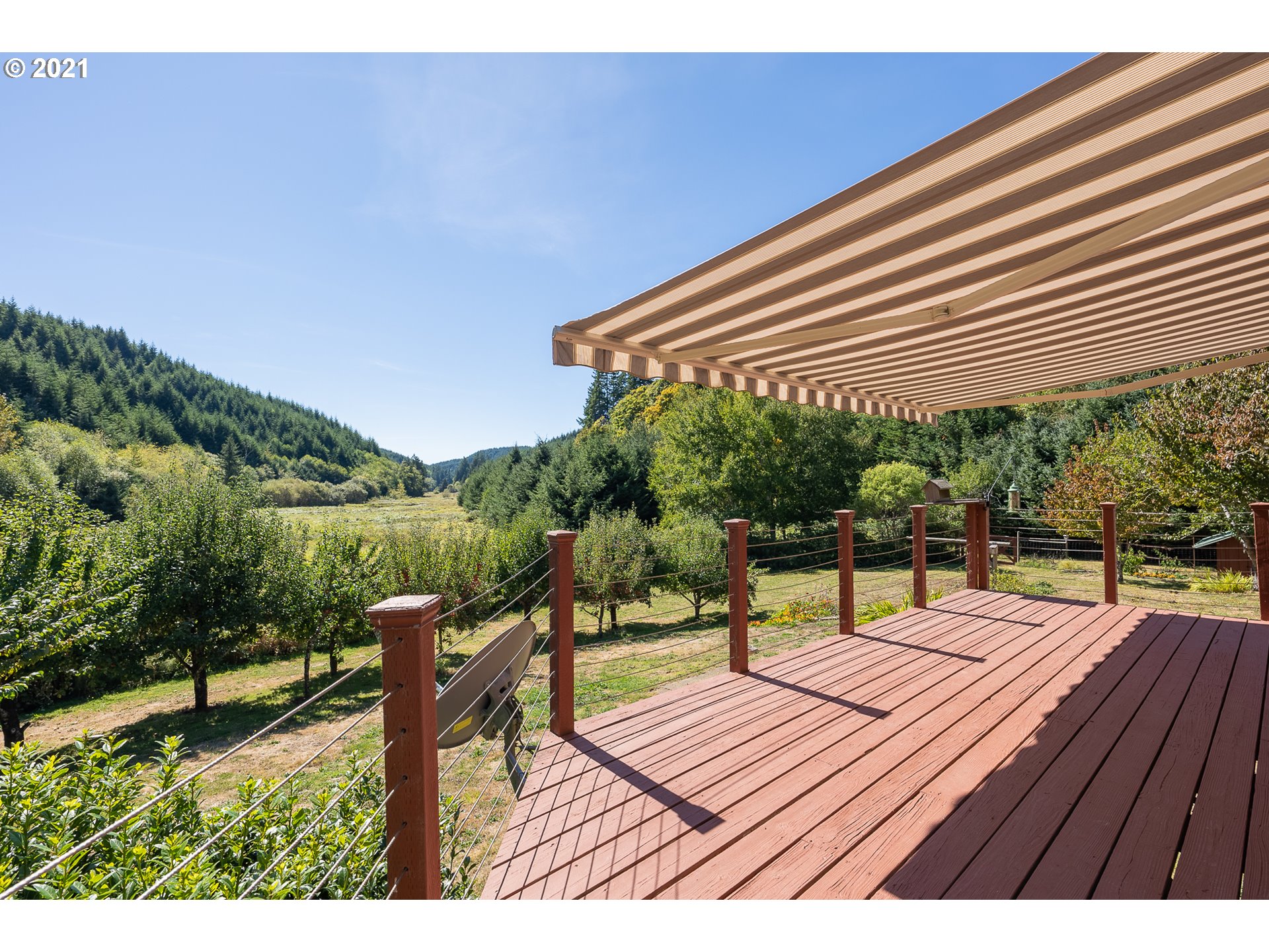 8715 Scholfield Road North Bend, OR 97459 - Photo 21 of 32 a balcony with wooden floor and outdoor seating