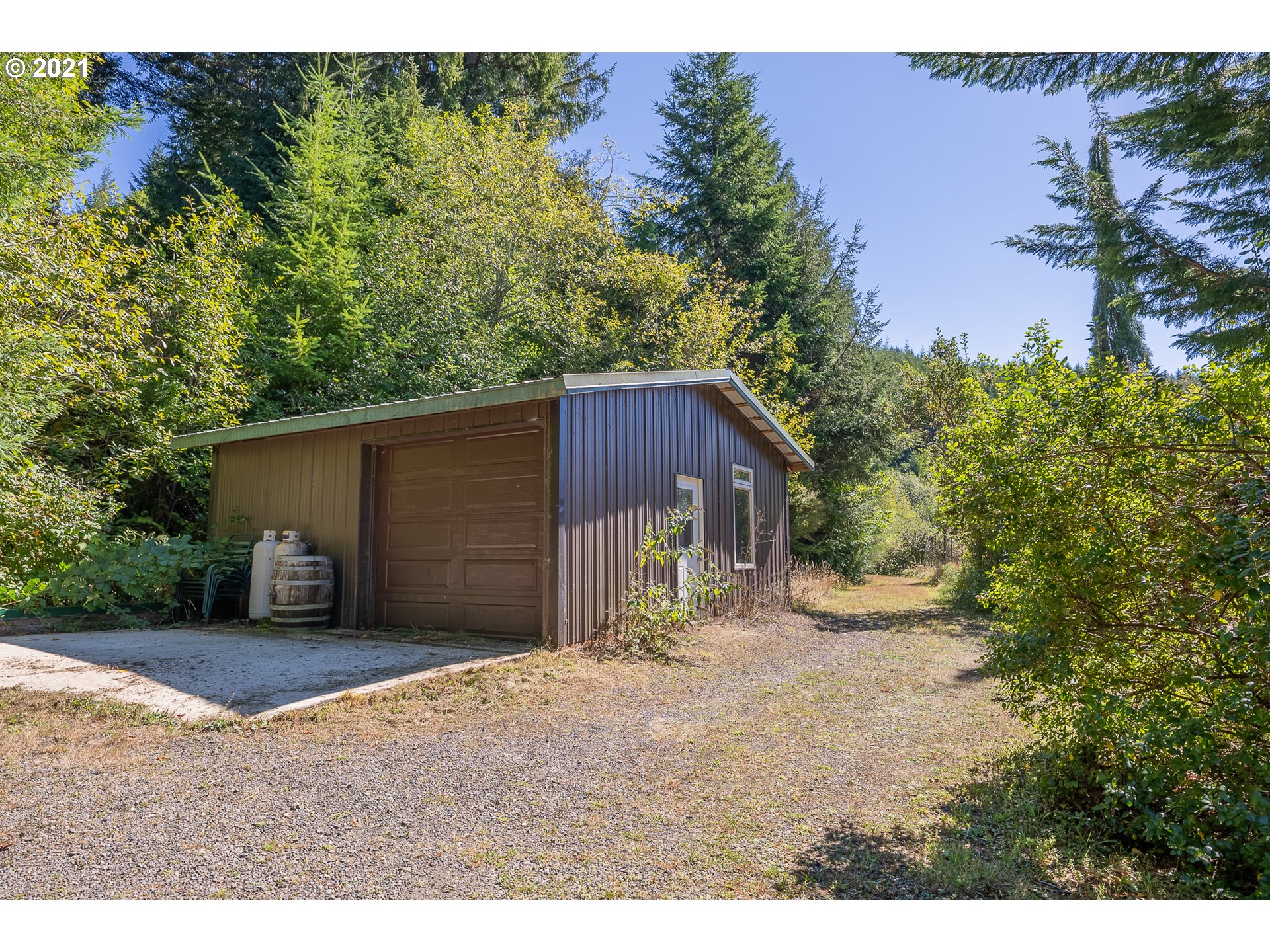 8715 Scholfield Road North Bend, OR 97459 - Photo 27 of 32 a view of a barn in the back yard