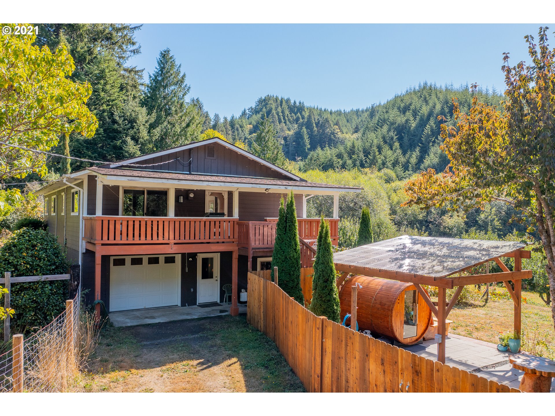 8715 Scholfield Road North Bend, OR 97459 - Photo 29 of 32 a view of a house with brick walls and a roof deck