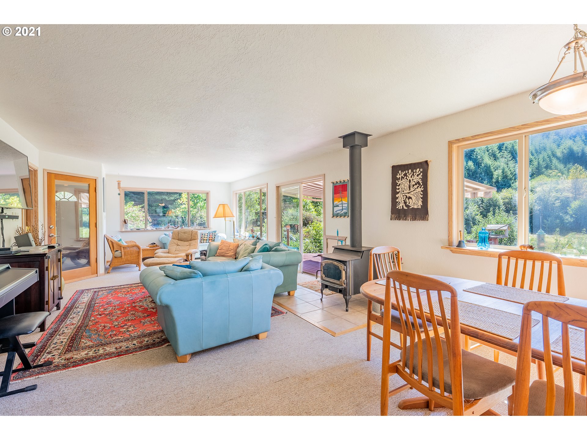 8715 Scholfield Road North Bend, OR 97459 - Photo 5 of 32 a living room with furniture and a large window