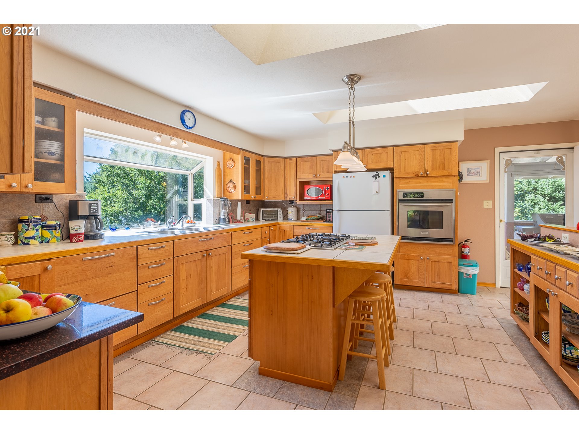 8715 Scholfield Road North Bend, OR 97459 - Photo 6 of 32 a kitchen that has a sink stainless steel appliances and window