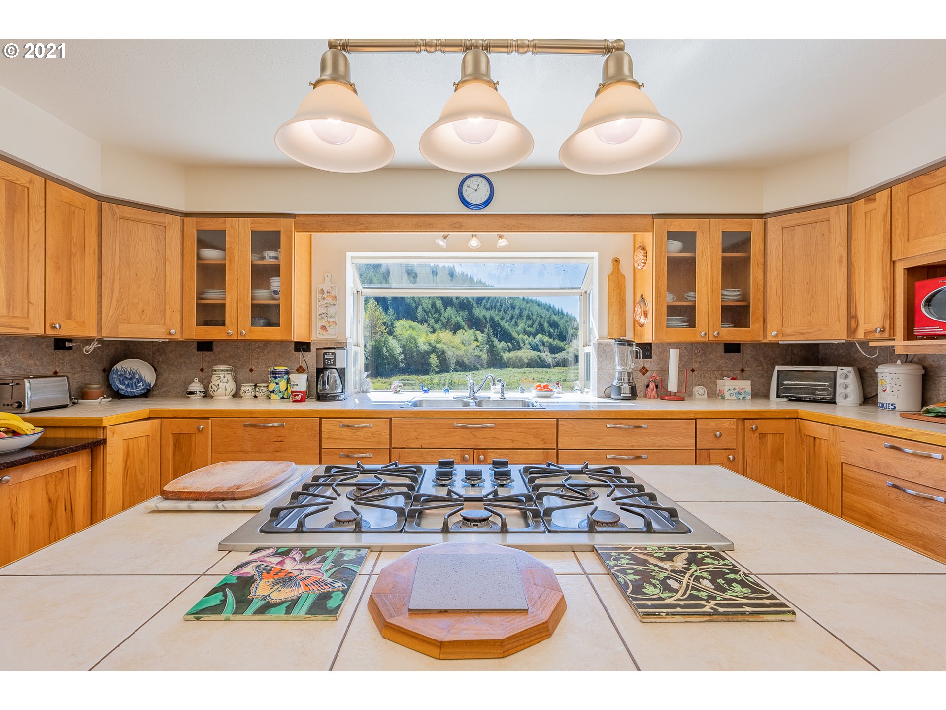 8715 Scholfield Road North Bend, OR 97459 - Photo 7 of 32 a kitchen with a stove a sink and a granite counter top
