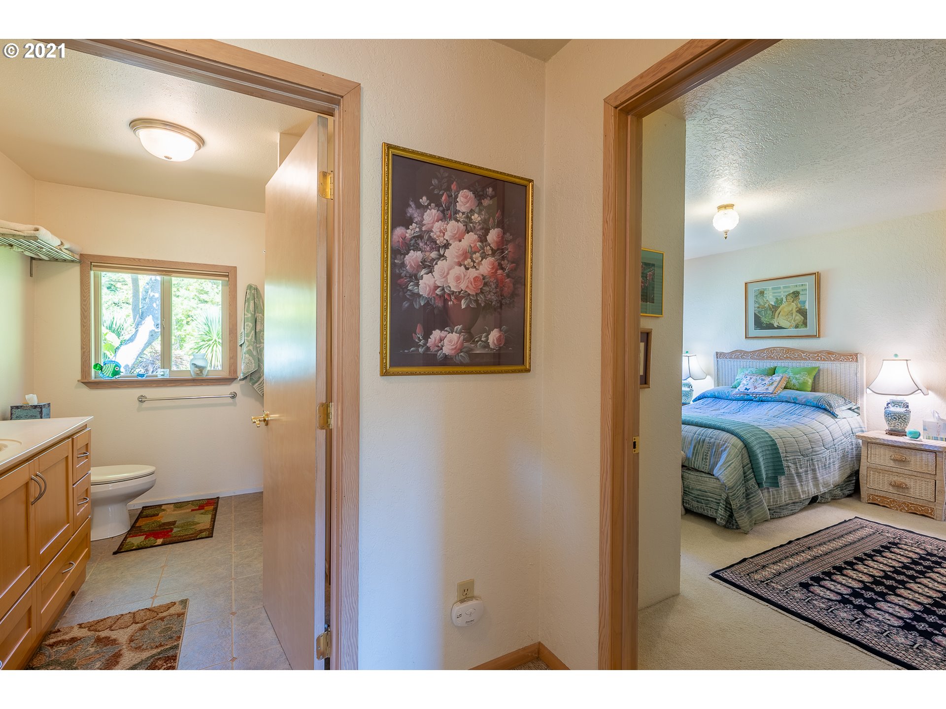 8715 Scholfield Road North Bend, OR 97459 - Photo 9 of 32 a bedroom with a bed and a view of bathroom