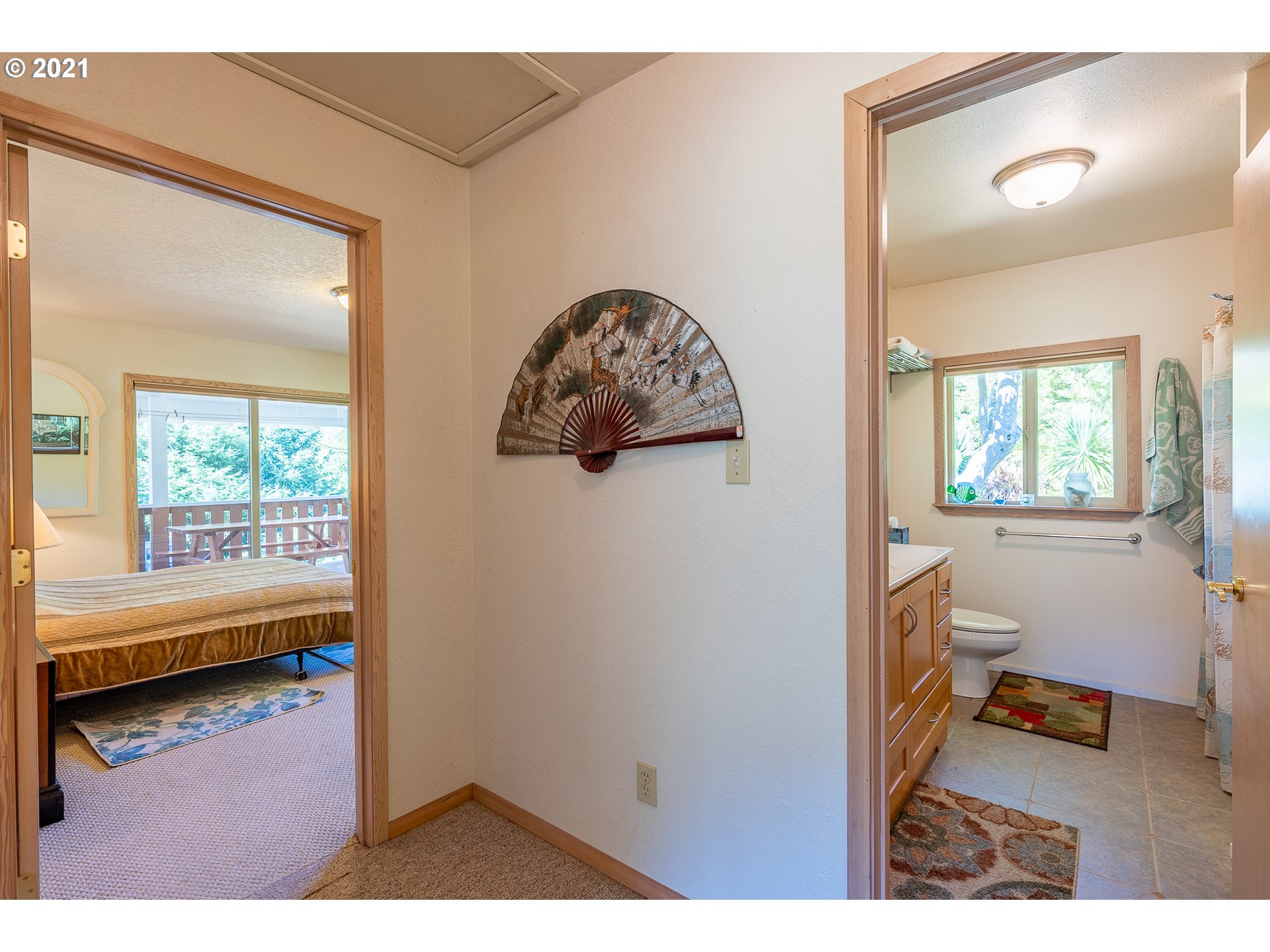 8715 Scholfield Road North Bend, OR 97459 - Photo 10 of 32 a view of a room that has a window and a wooden floor
