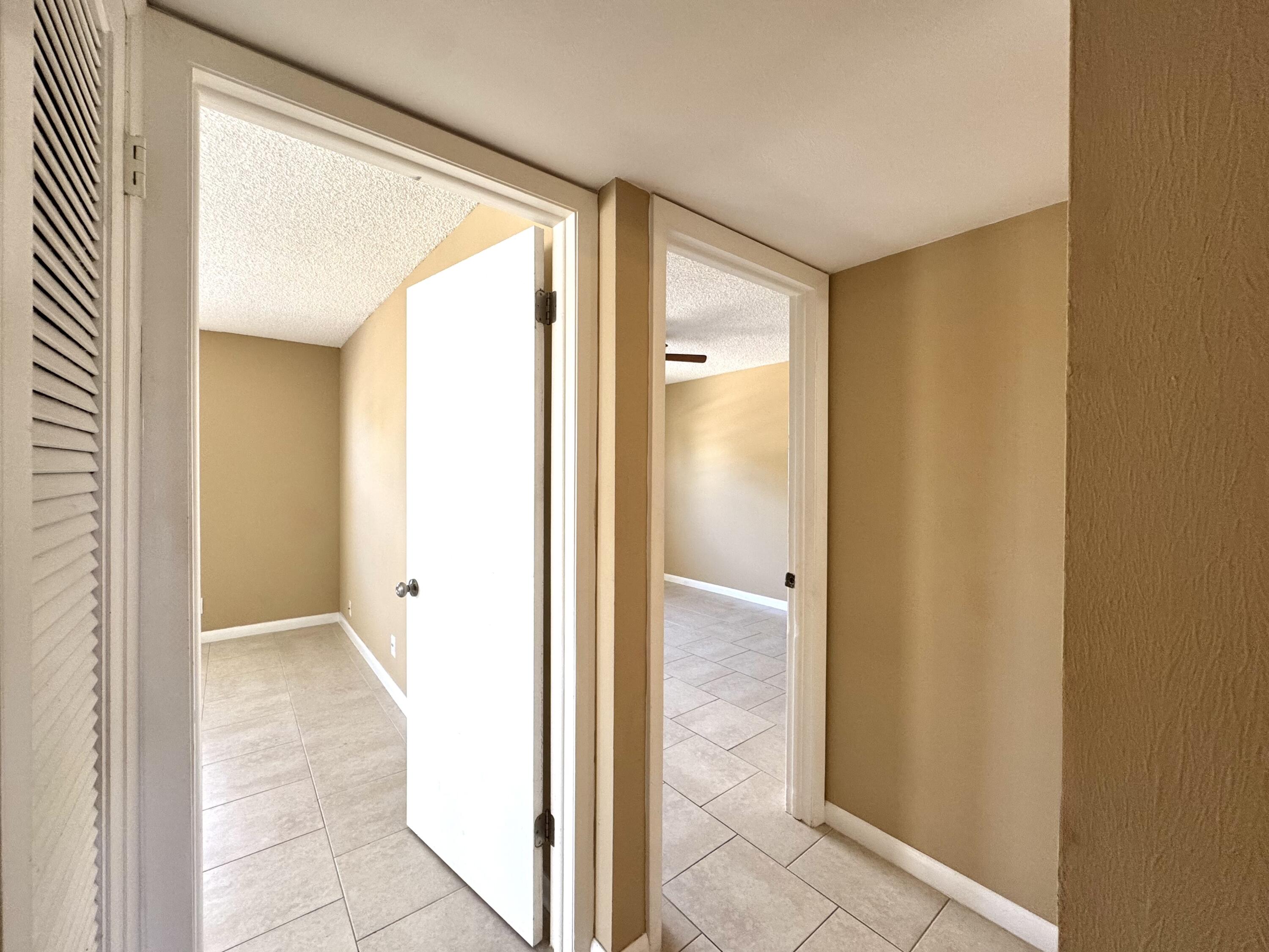 900 Normandy Lane Delray Beach, FL 33484 - Photo 13 of 22 a view of a bathroom from a hallway