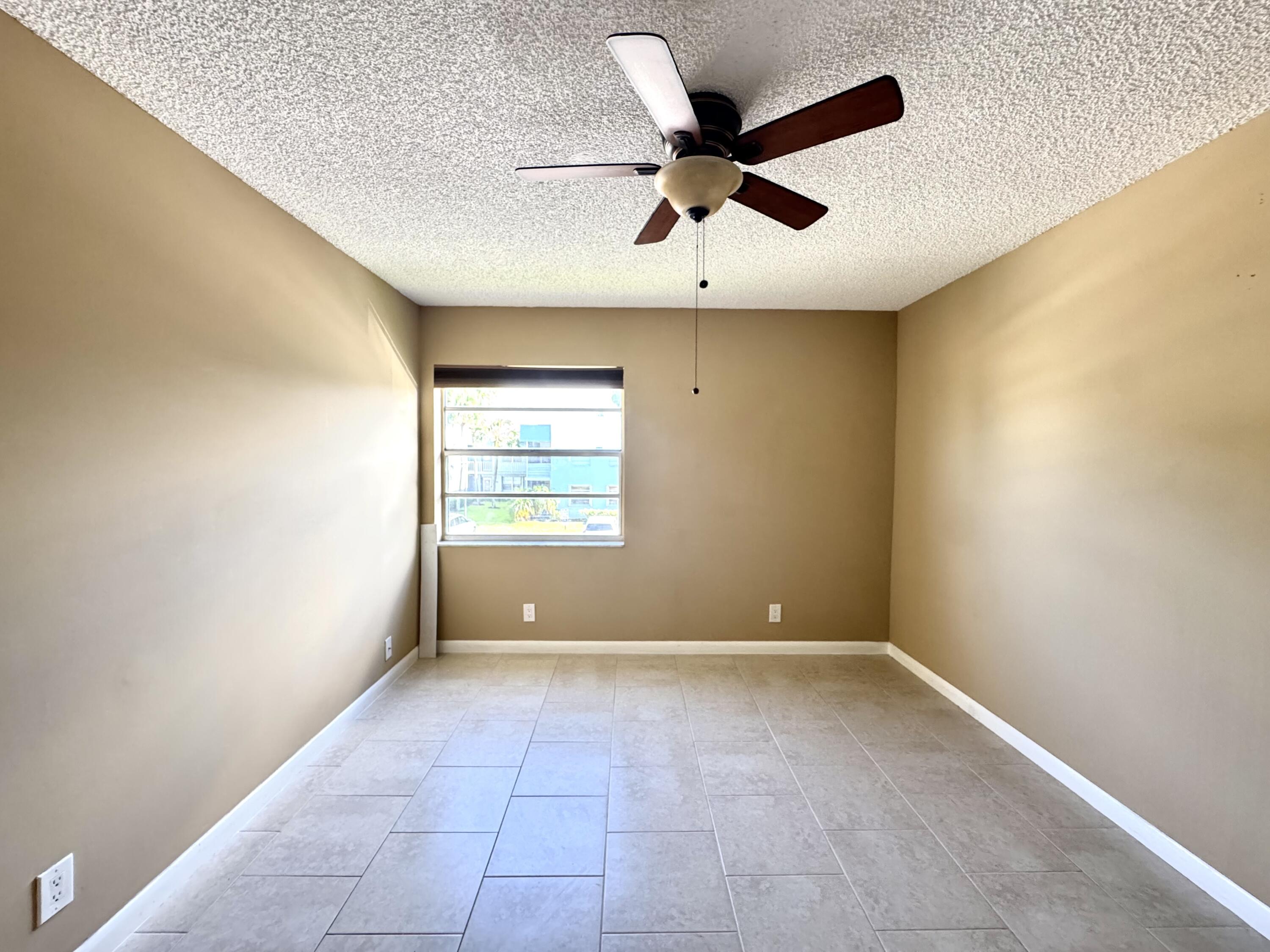 900 Normandy Lane Delray Beach, FL 33484 - Photo 19 of 22 an empty room with ceiling fan and windows