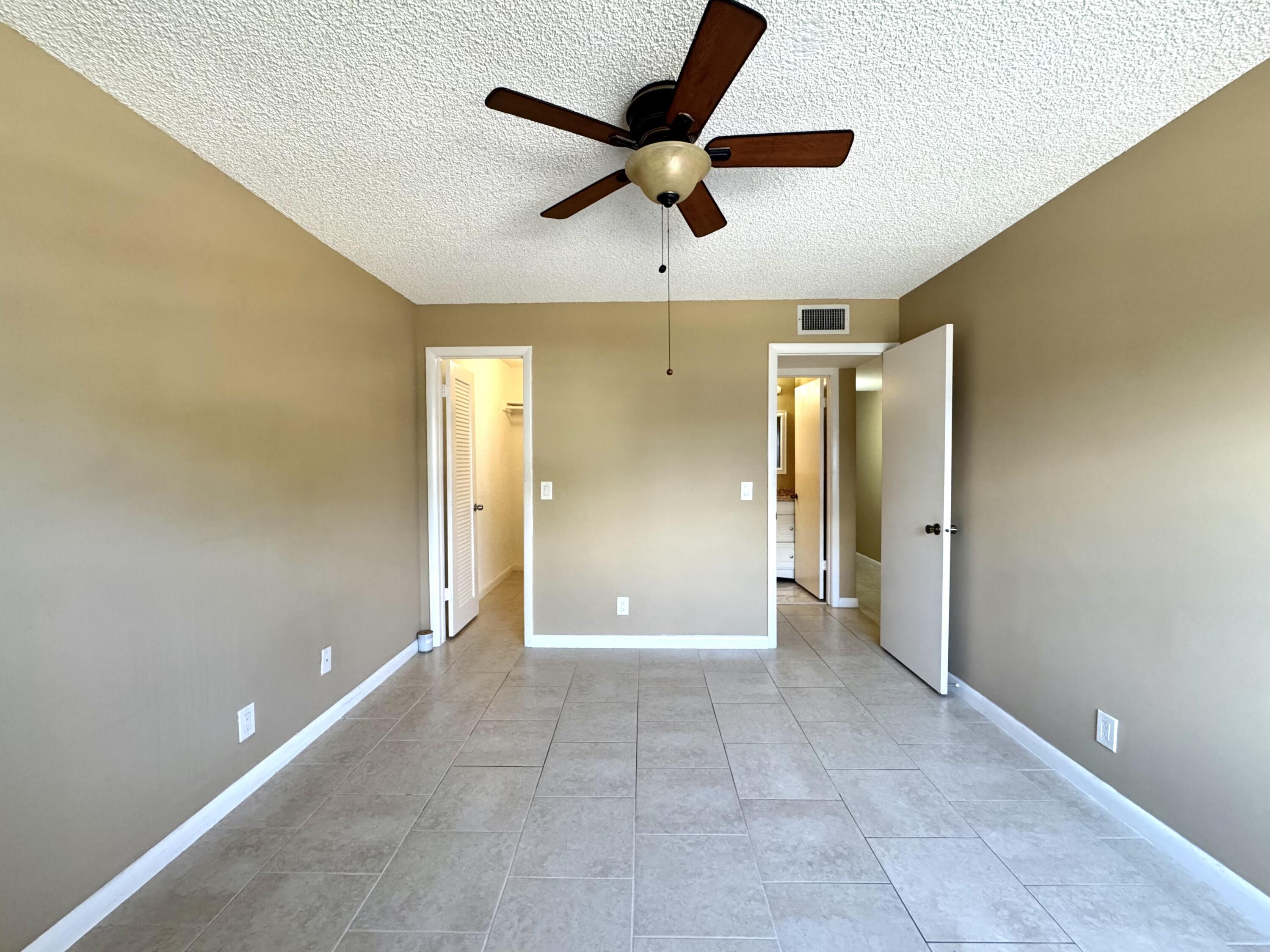 900 Normandy Lane Delray Beach, FL 33484 - Photo 20 of 22 a view of a livingroom with a ceiling fan and entryway
