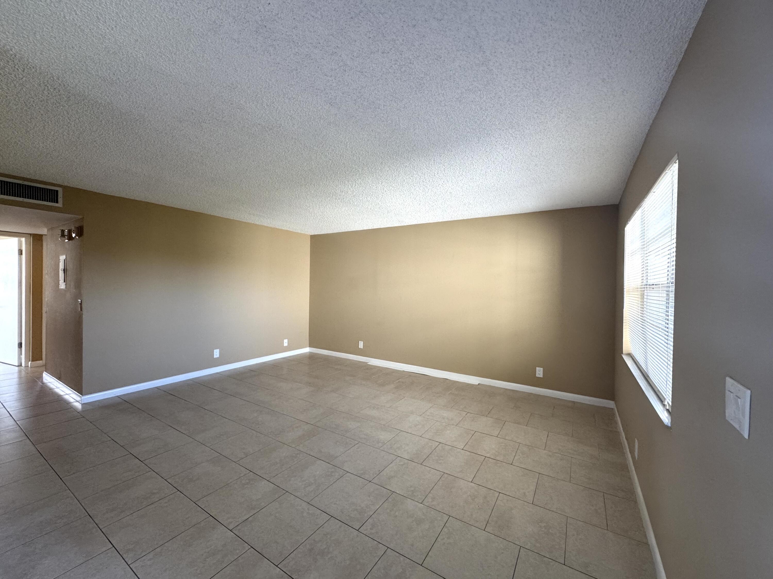 900 Normandy Lane Delray Beach, FL 33484 - Photo 3 of 22 a view of an empty room with a window