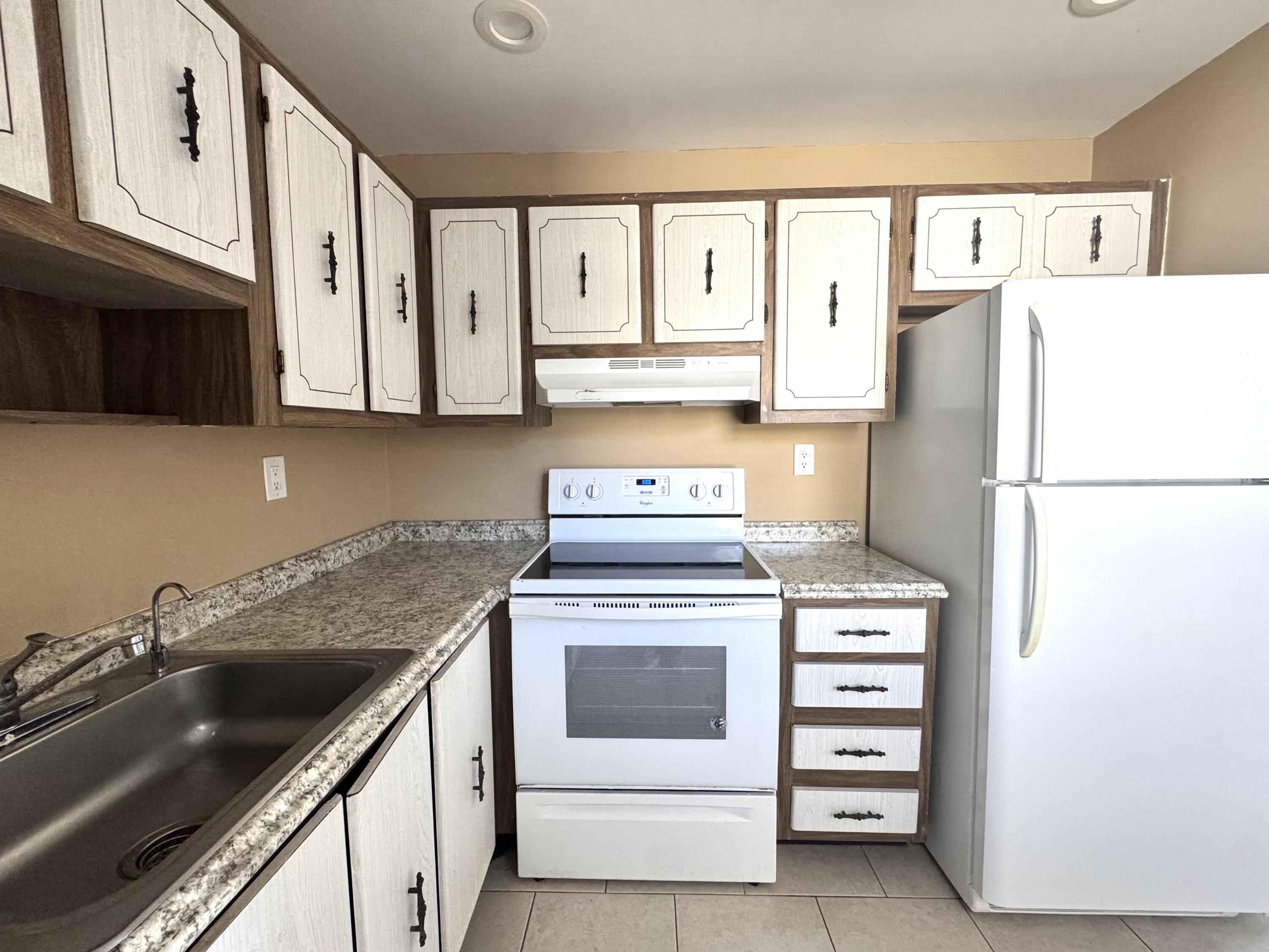 900 Normandy Lane Delray Beach, FL 33484 - Photo 8 of 22 a kitchen with cabinets appliances and a sink