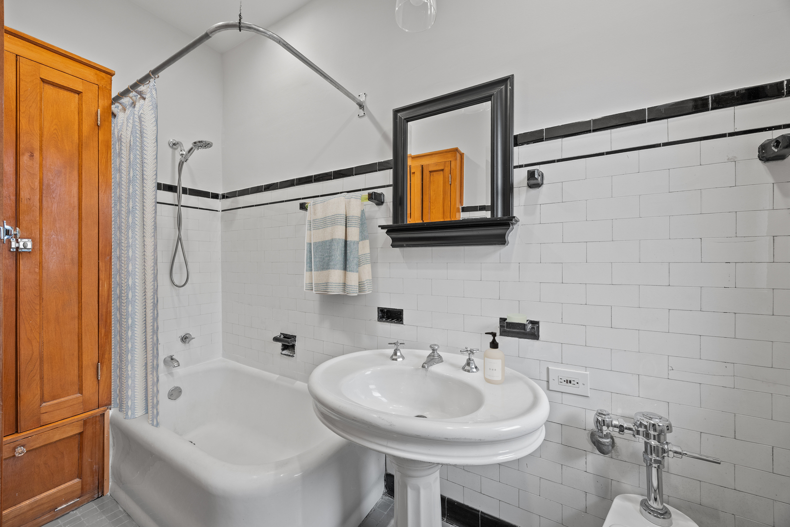 1352 East Madison Park, Unit 2 Chicago, IL 60615 - Photo 14 of 17 a bathroom with a sink a mirror and a bathtub