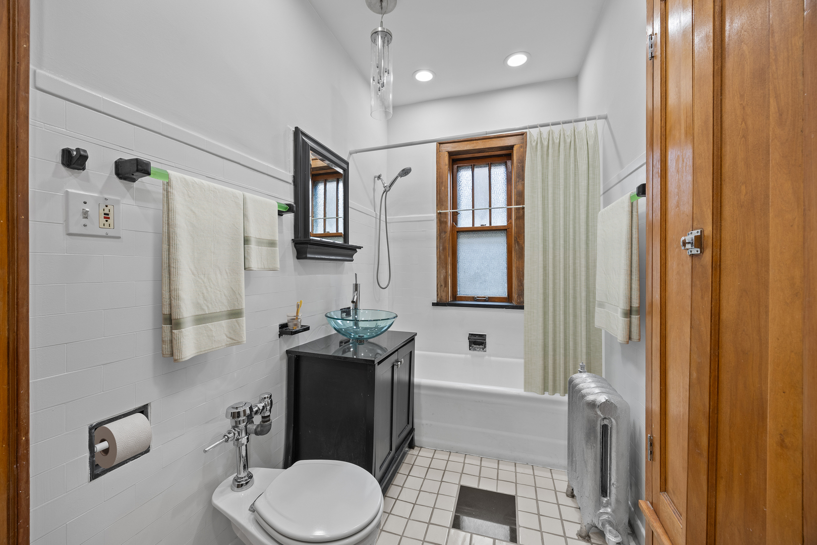1352 East Madison Park, Unit 2 Chicago, IL 60615 - Photo 17 of 17 a bathroom with a toilet a sink and mirror