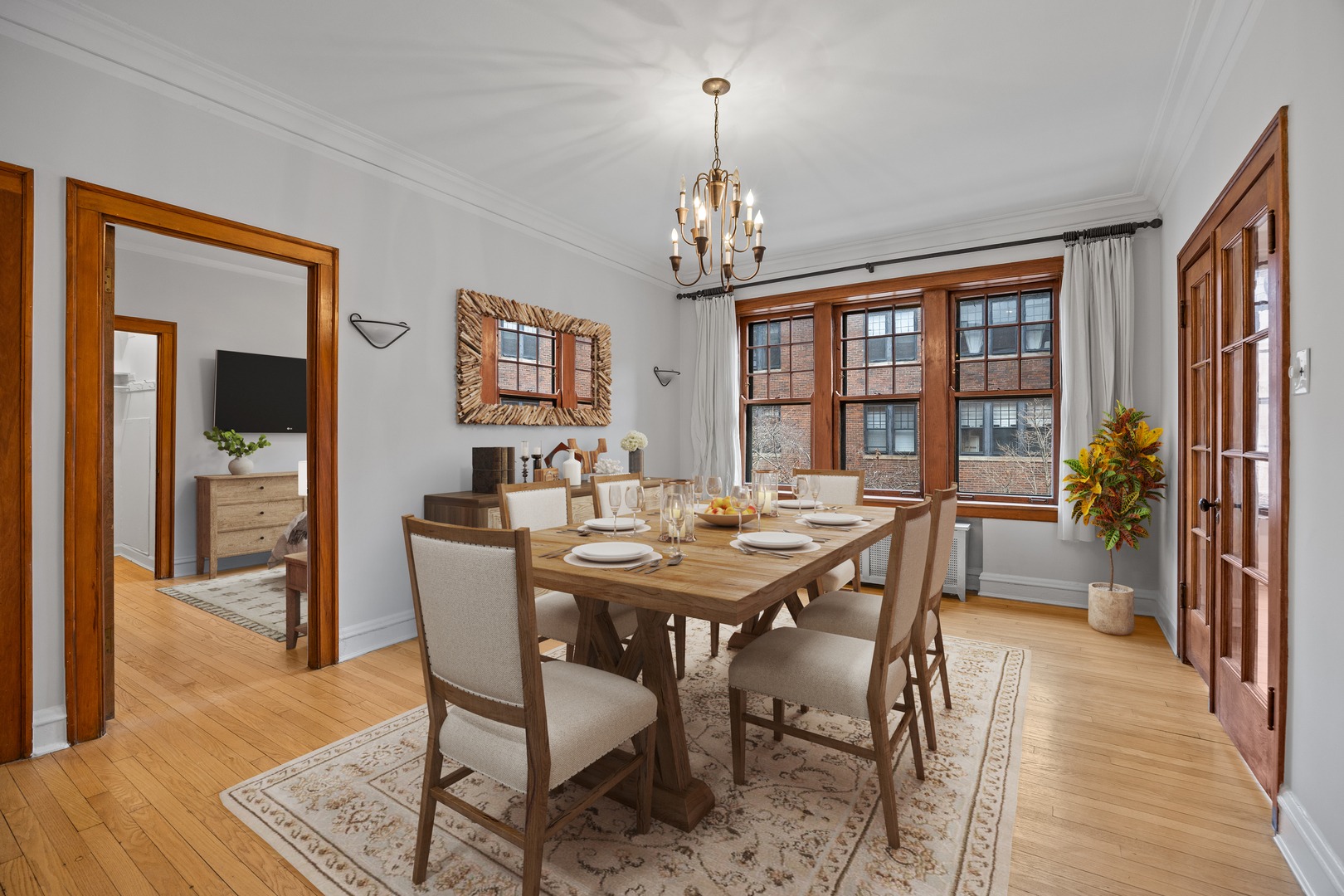 1352 East Madison Park, Unit 2 Chicago, IL 60615 - Photo 6 of 17 a view of a dining room with furniture a chandelier and wooden floor