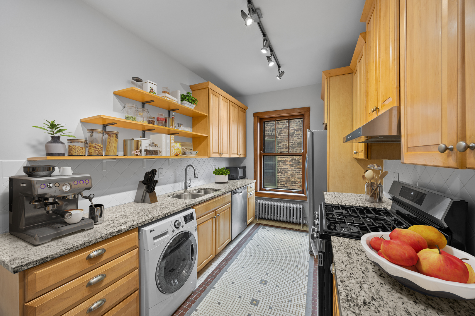 1352 East Madison Park, Unit 2 Chicago, IL 60615 - Photo 8 of 17 a kitchen with stainless steel appliances granite countertop a sink and cabinets