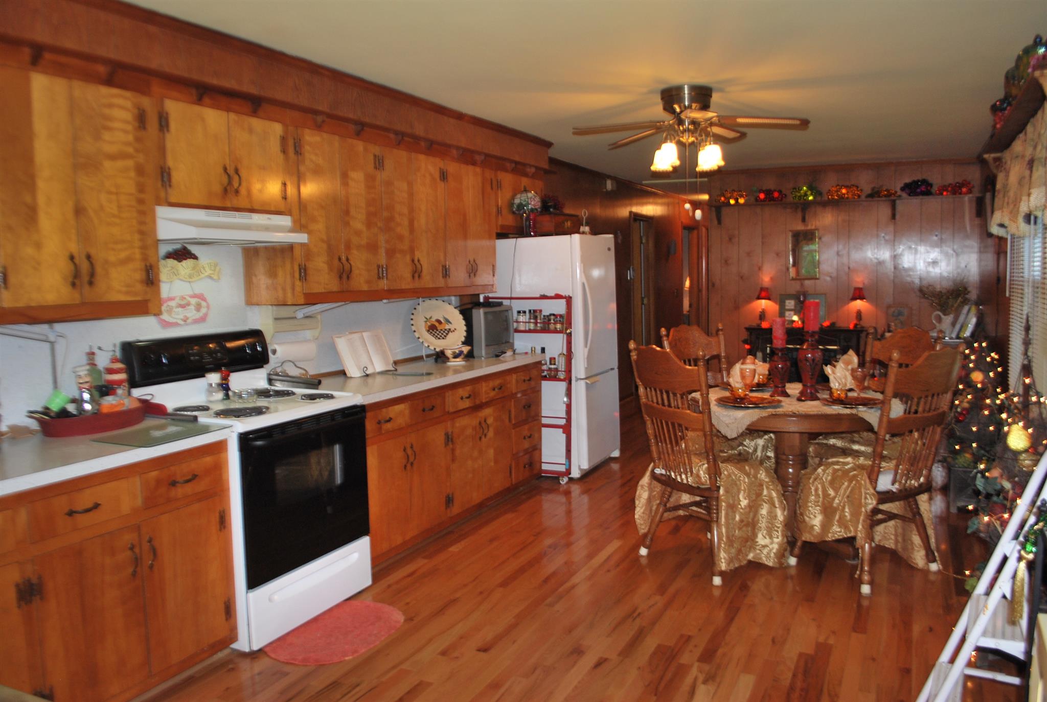 180 Sam Hollow Road Dickson, TN 37055 - Photo 4 of 18 a kitchen with stainless steel appliances kitchen island granite countertop a table chairs in it and wooden floors