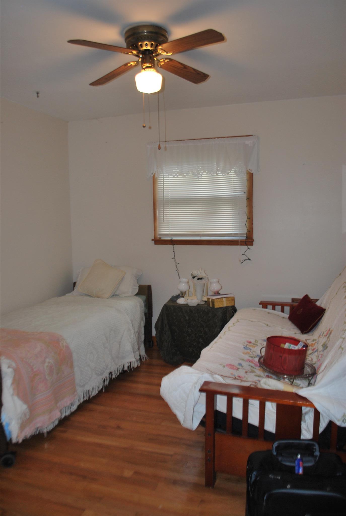 180 Sam Hollow Road Dickson, TN 37055 - Photo 7 of 18 a bedroom with a bed and a chandelier