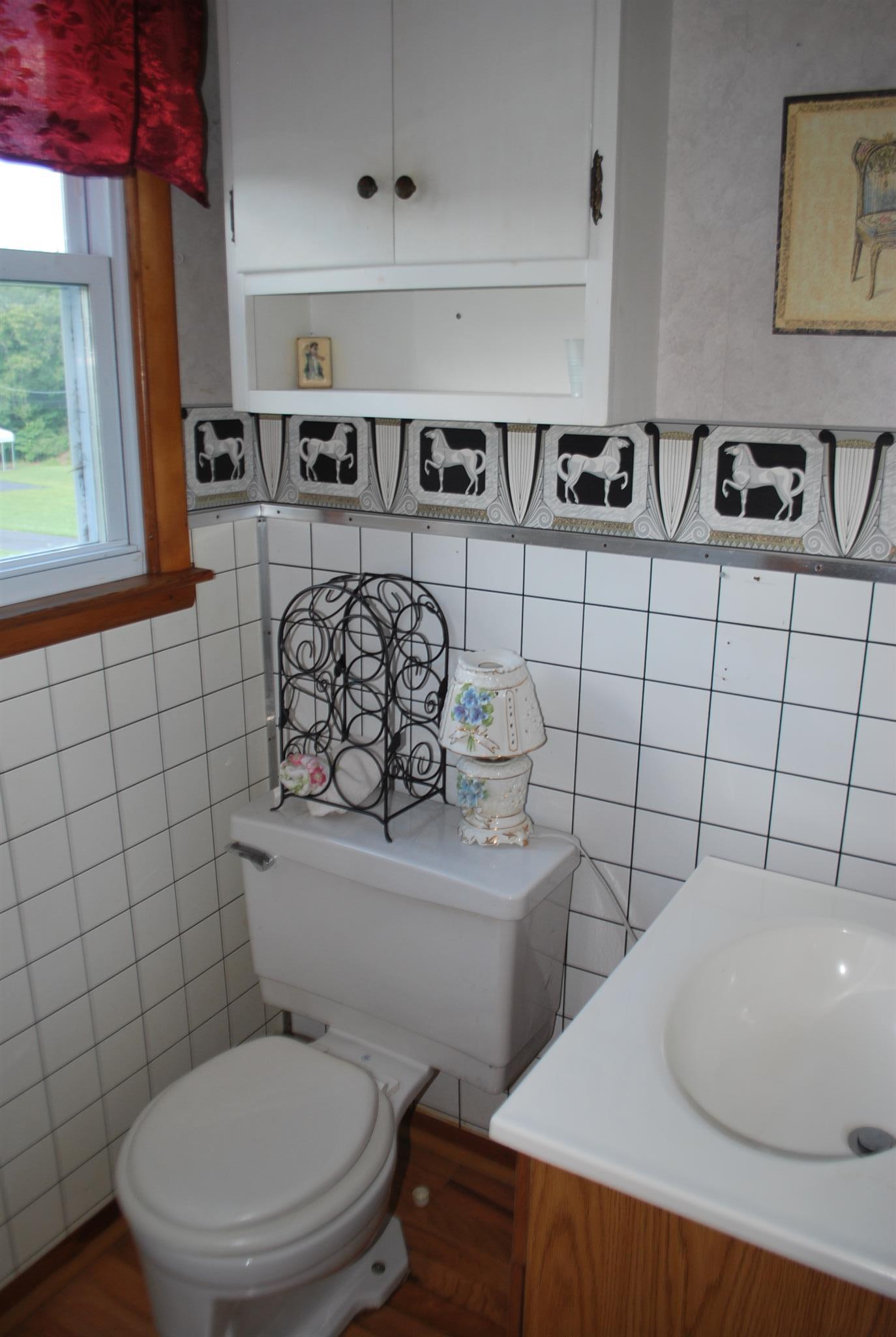 180 Sam Hollow Road Dickson, TN 37055 - Photo 10 of 18 a bathroom with a toilet sink and mirror