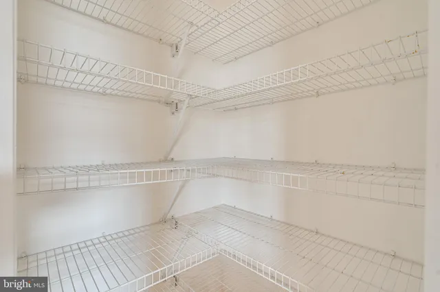 a bathroom with a granite countertop shower a sink and a mirror