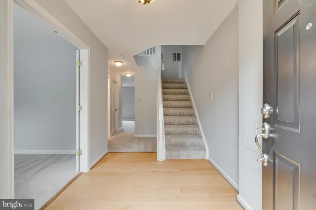 a view of a hallway with a white walls and stairs