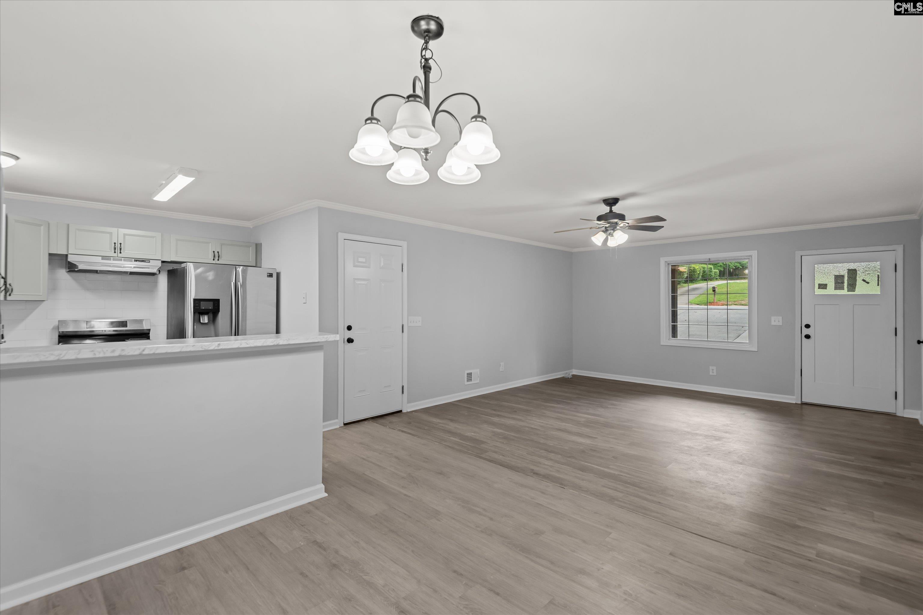 245 Piney Grove Road Columbia, SC 29210 - Photo 12 of 29 an empty room with wooden floor cabinet and windows