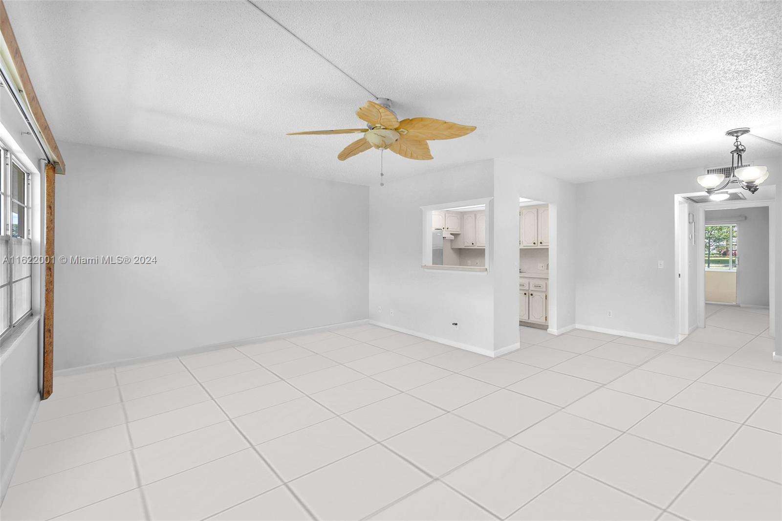 306 Preston H, Unit 306 Boca Raton, FL 33434 - Photo 4 of 79 an empty room with chandelier fan and windows