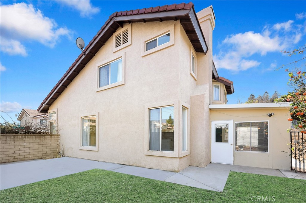 7190 Trivento Place Rancho Cucamonga, CA 91701 - Photo 12 of 13 a view of a house with a yard